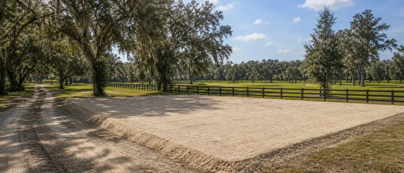 Level barn or shop pad beside fenced equestrian acreage near Alachua, Florida.